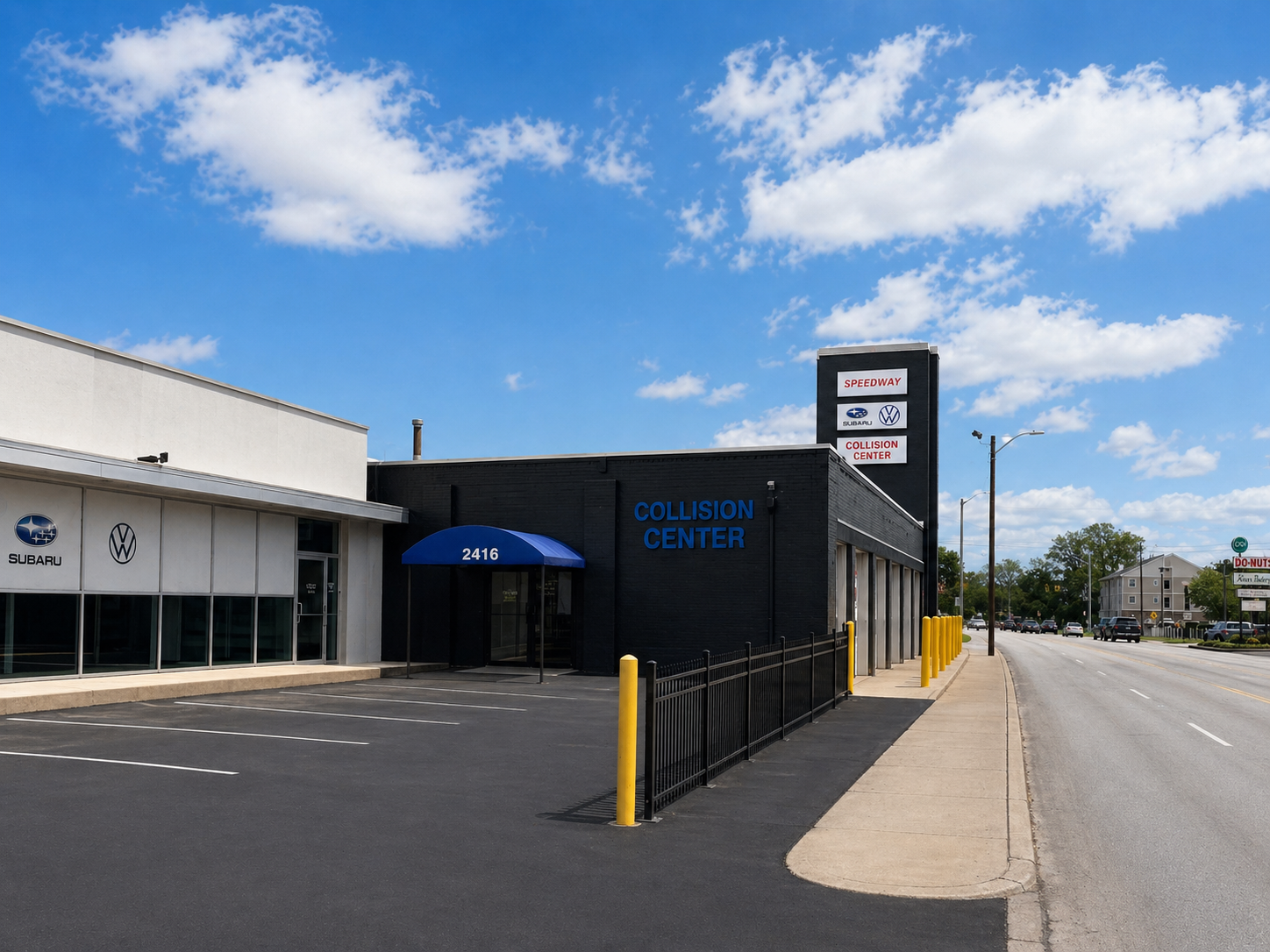 Speedway Collision Center building in Indianapolis — premium auto body repair facility with Subaru and Volkswagen vehicles